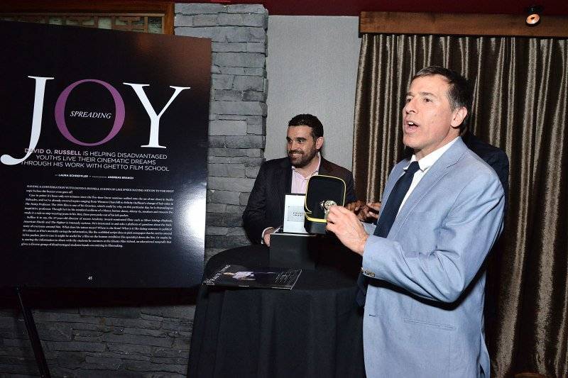 David O. Russell accepts a watch from Graham on behalf of Ghetto Film School