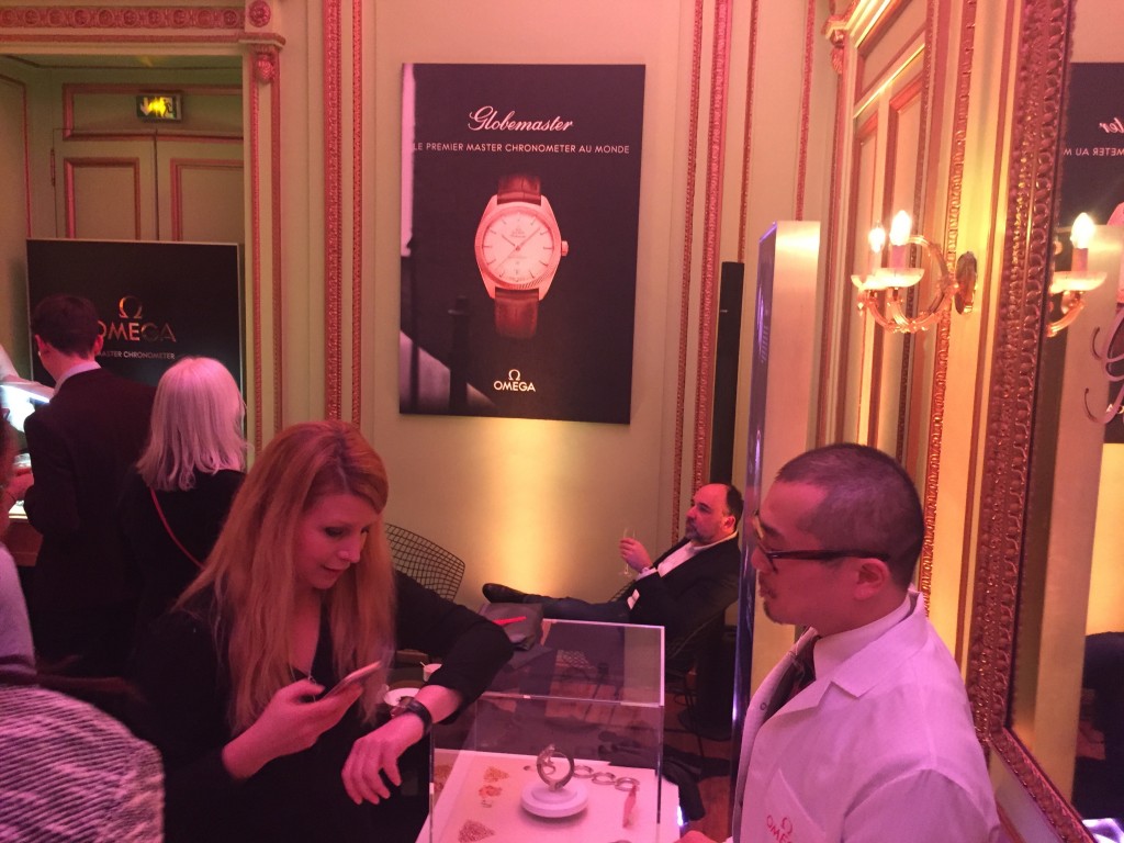 Trying on the Omega Globemaster for size at Maxim's Paris